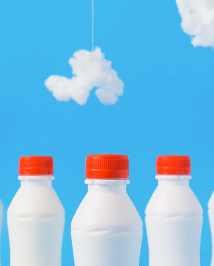 Milk Bottles in front of some clouds
