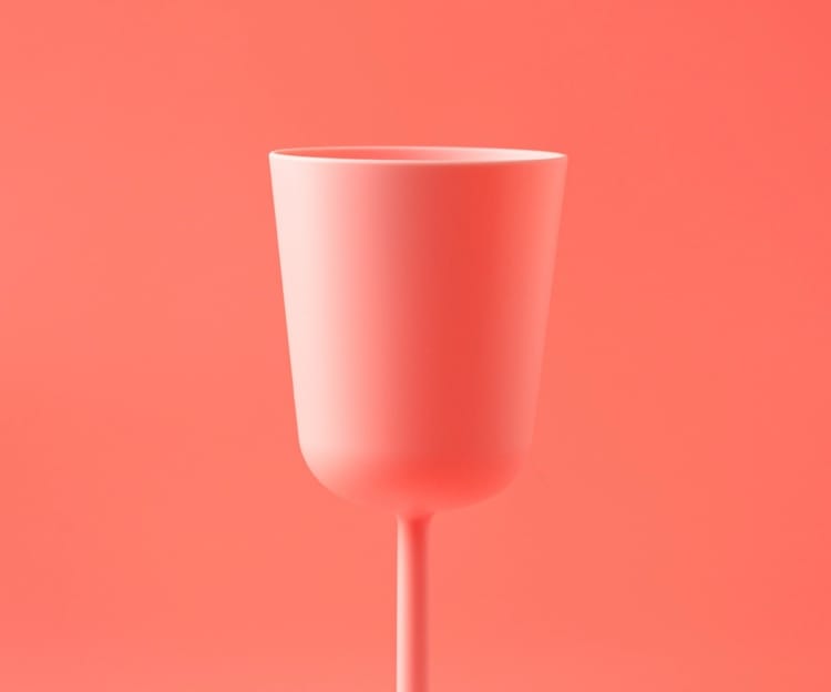 A glass of wine on a soft red background